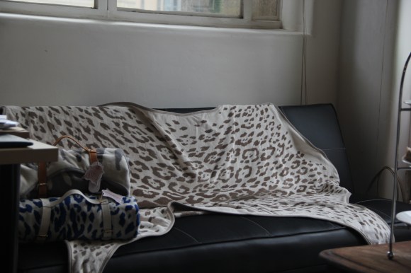 This is cool. It's a beach towel that is in a shape of a giant animal hide. Disclaimer: no animals hurt in the making of this beach towel. It rolls up into that handy bundle on the side.