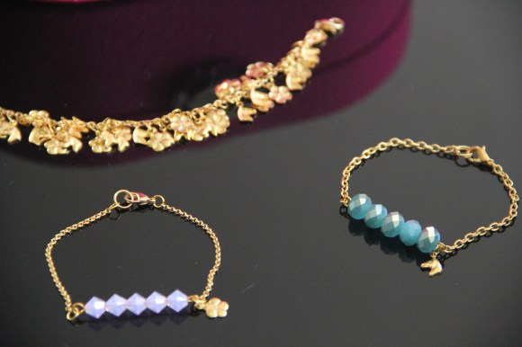 I added little charms to all of my bracelets. Swarovski crystal bracelets in aqua blue and lilac purple. Charm bracelet. 